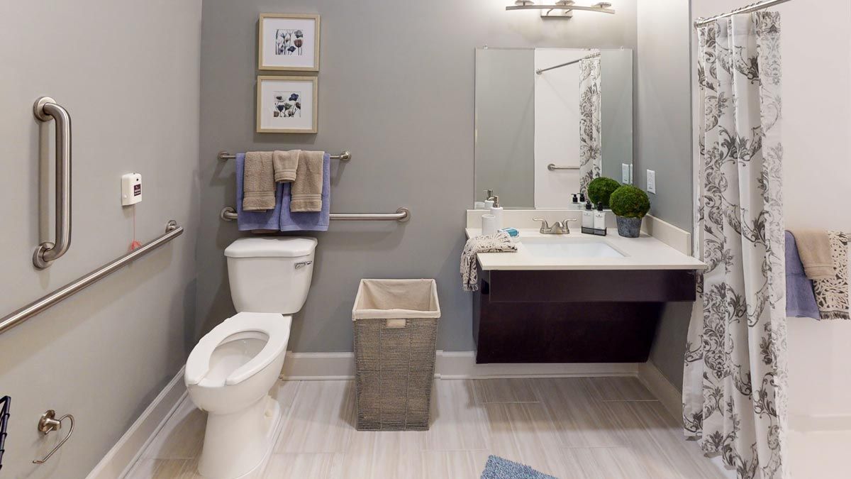 A modern bathroom with a toilet, sink, and stylish decor.