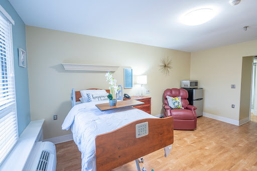 A well-lit and comfortable hospital room designed for patient care and rehabilitation.