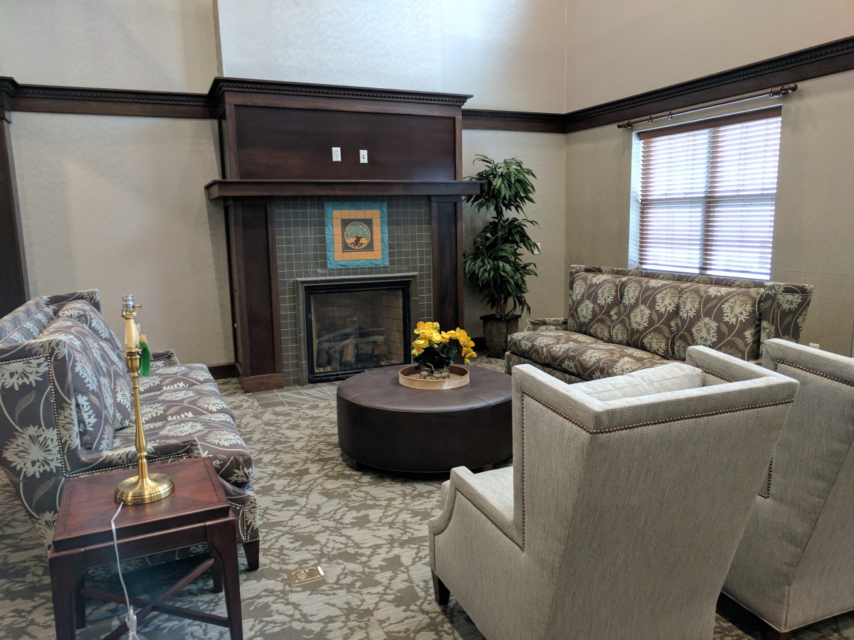 A cozy living room with a fireplace, comfortable seating, and elegant decor.