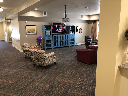 A cozy living room featuring comfortable seating, a television, and a decorative blue cabinet.