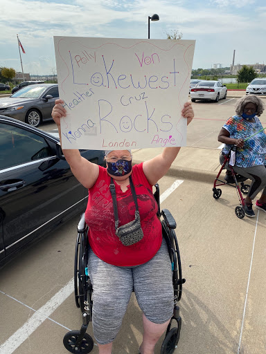 A protester in a wheelchair holding a sign, advocating for their cause.