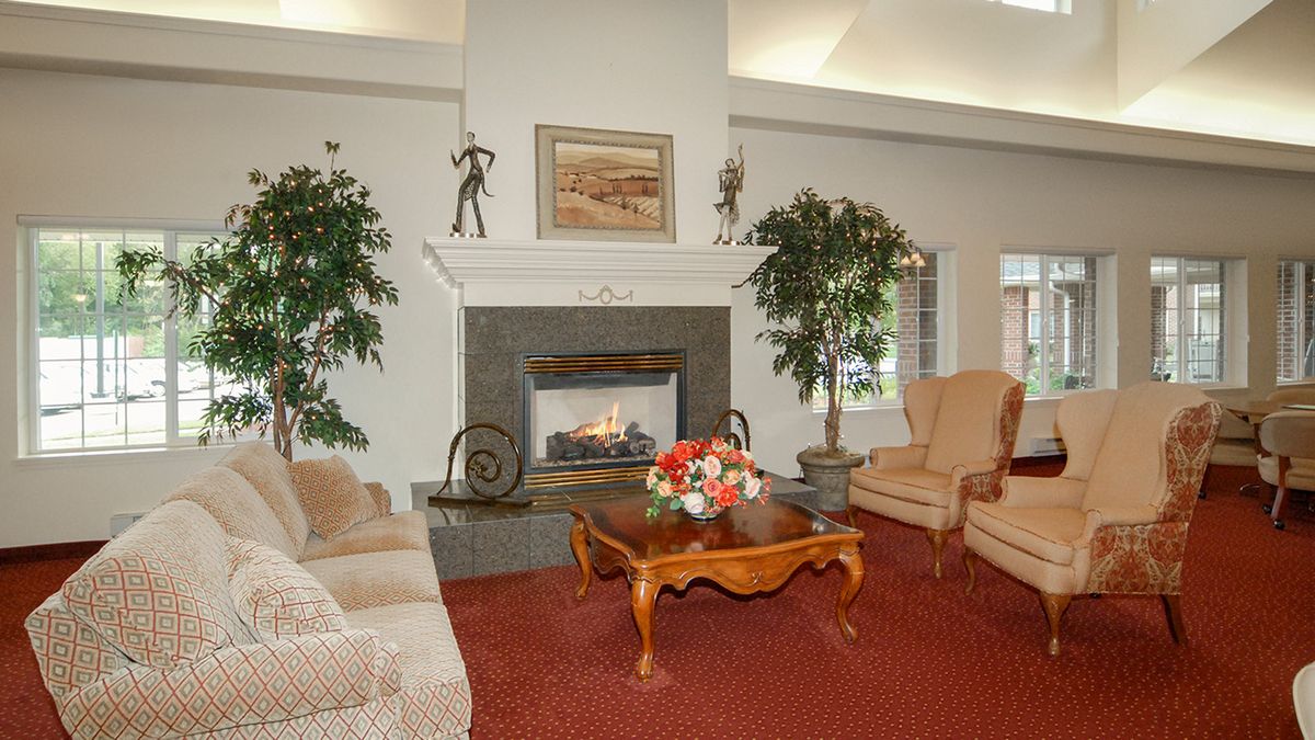 A cozy living room with a fireplace, comfortable seating, and decorative elements.