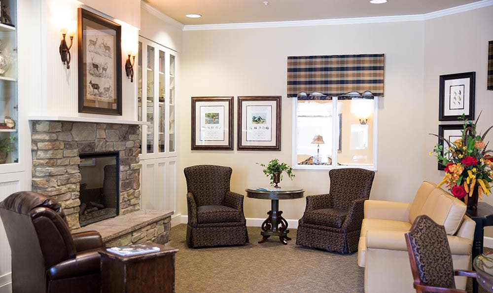A cozy living room with a fireplace, comfortable seating, and tasteful decor.