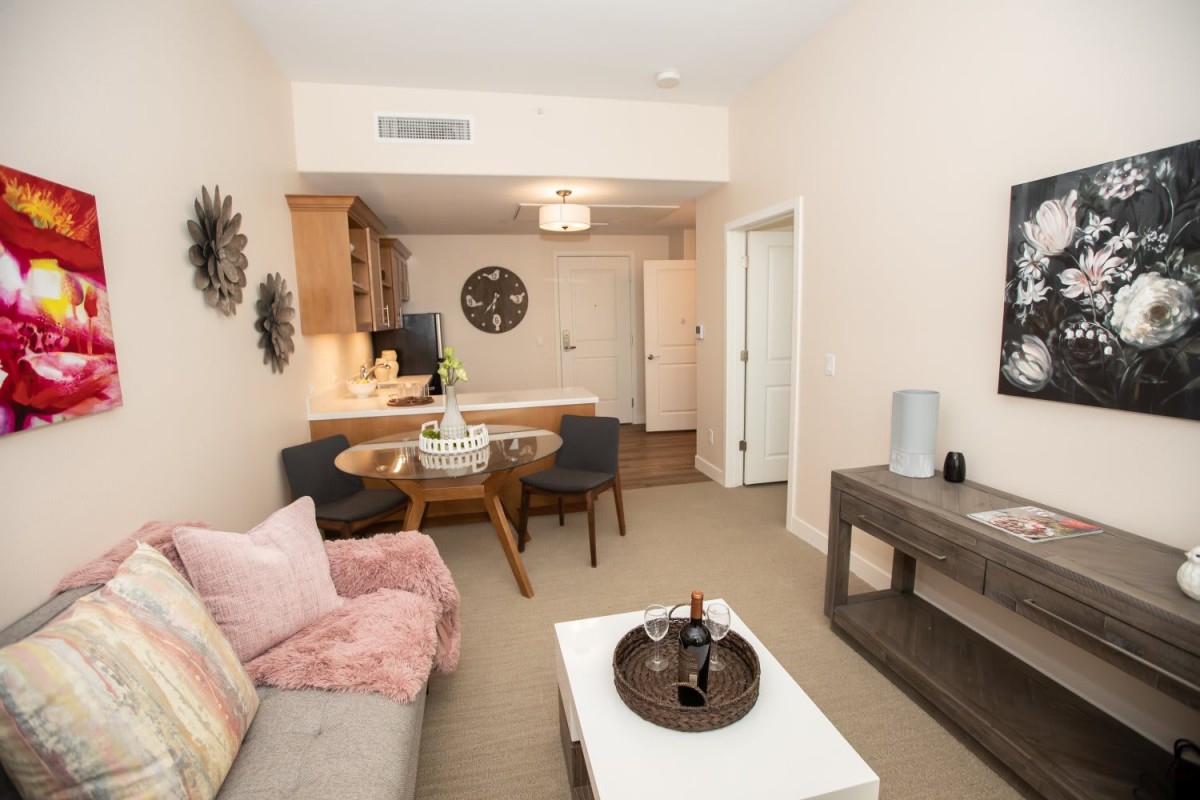 A modern apartment living room with a cozy dining area and contemporary decor.