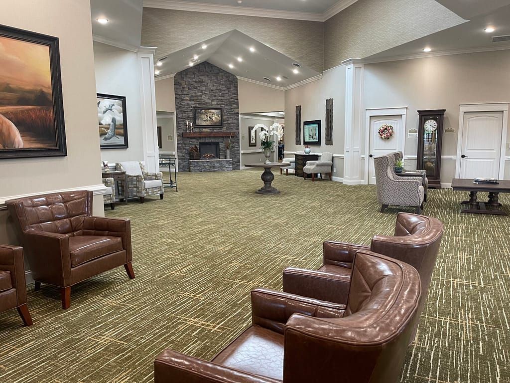 A spacious lobby with comfortable seating and a fireplace.