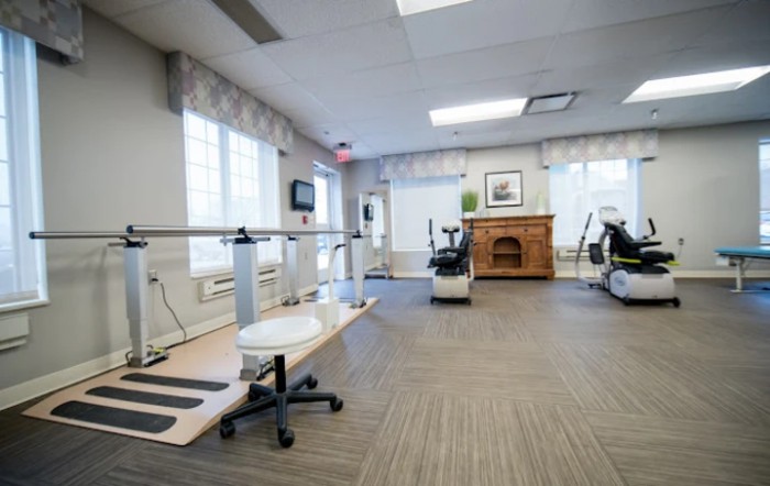 A well-equipped rehabilitation and therapy room with exercise equipment.