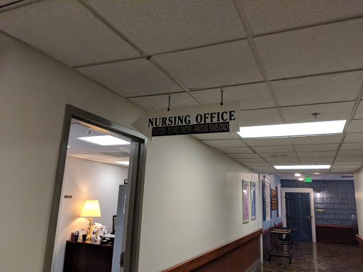 A sign indicating the location of the leasing office in a building.