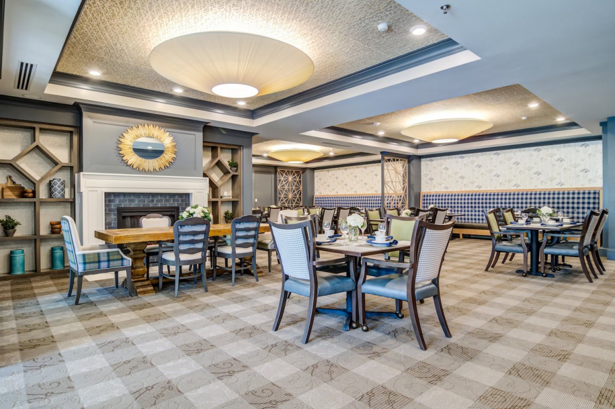 An elegantly designed dining area with neatly arranged tables and chairs.