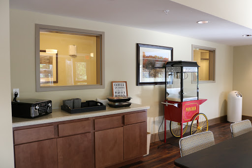 A cozy interior featuring a snack bar with a popcorn machine and wooden cabinets.