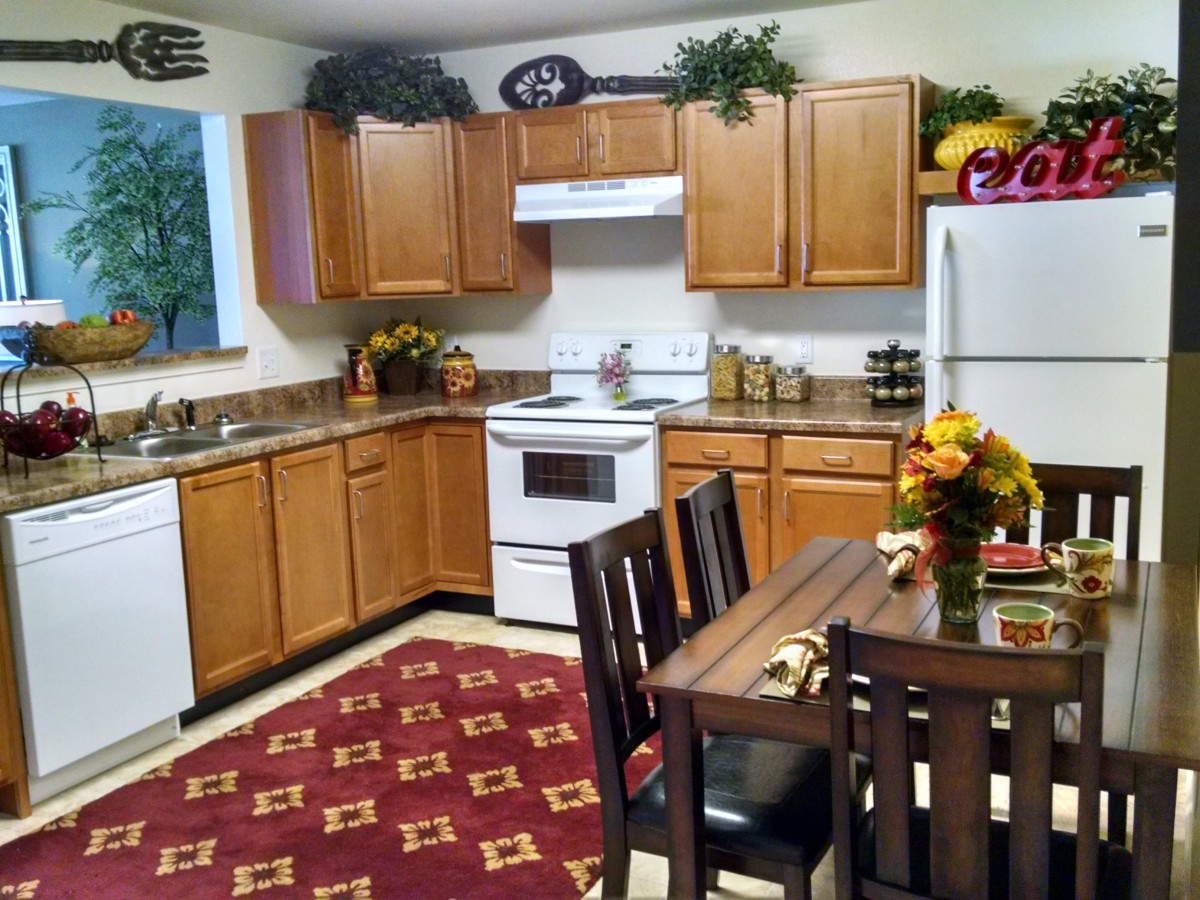 Cozy kitchen with wooden cabinets and a small dining area.