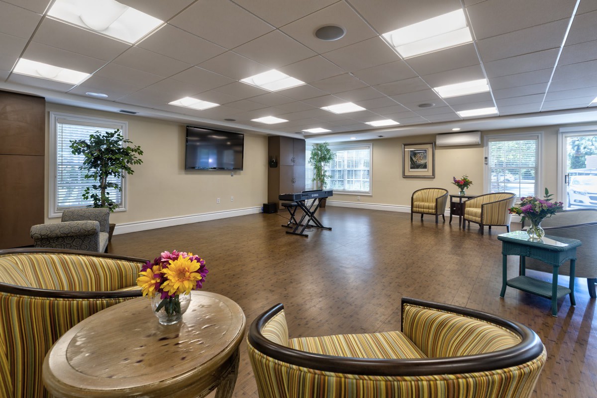 A spacious lounge area with comfortable seating and decorative plants.