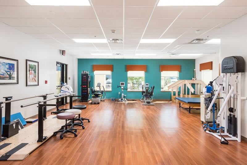 A spacious rehabilitation center equipped with various physical therapy equipment and facilities.