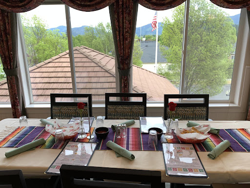 A beautifully arranged dining table with a scenic mountain view.