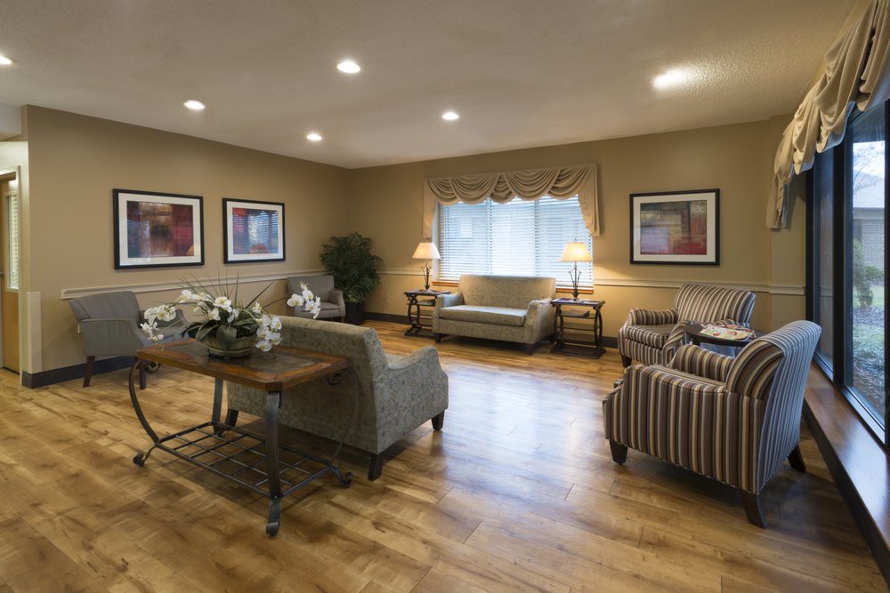 A cozy living room with sofas, chairs, and elegant decor.