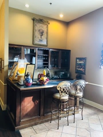 A cozy home bar setup with stools and a well-organized countertop.