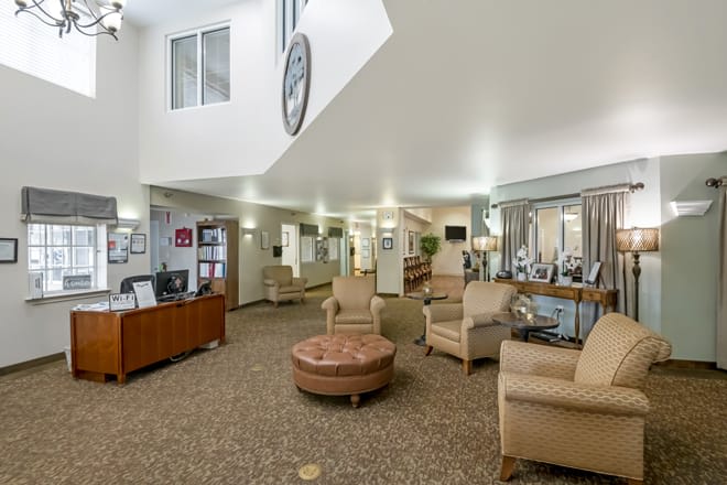 A spacious lobby area with comfortable seating and a reception desk.