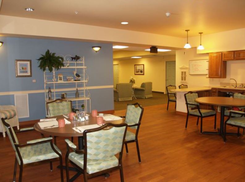 A cozy dining area with neatly set tables and comfortable seating.