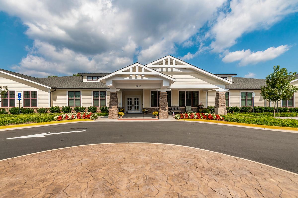 A suburban building with a welcoming entrance set against a cloudy sky.