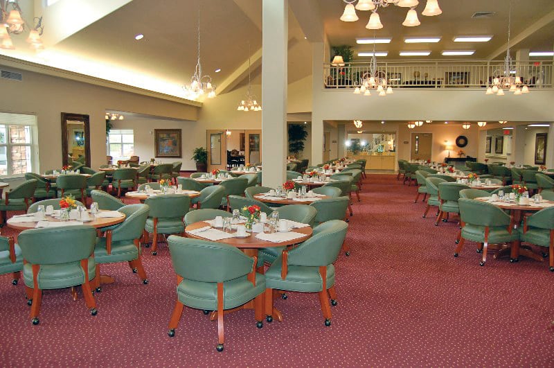 An elegant and spacious dining room with neatly arranged tables and chairs.
