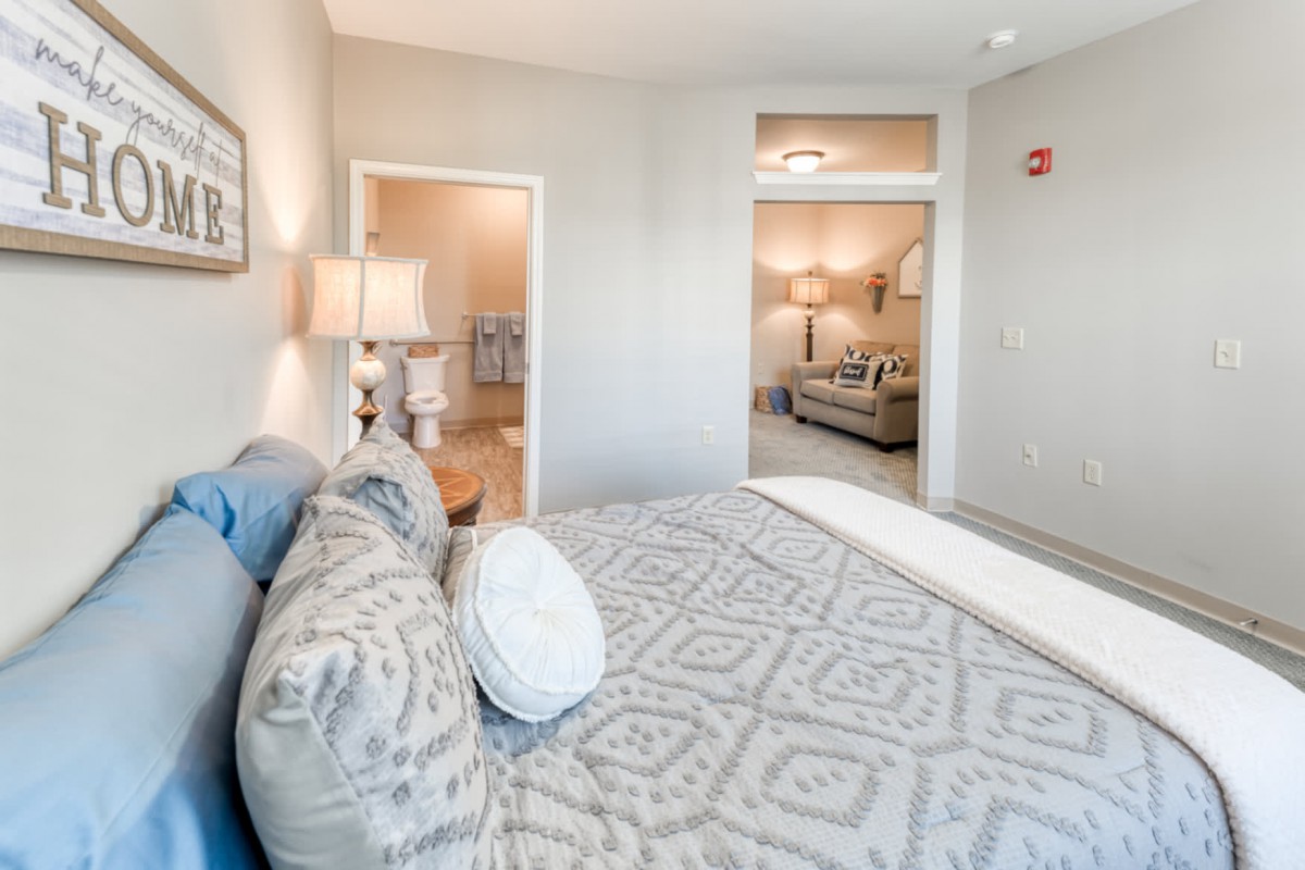 A cozy bedroom with soft lighting and elegant decor, featuring a comfortable bed and modern furnishings.