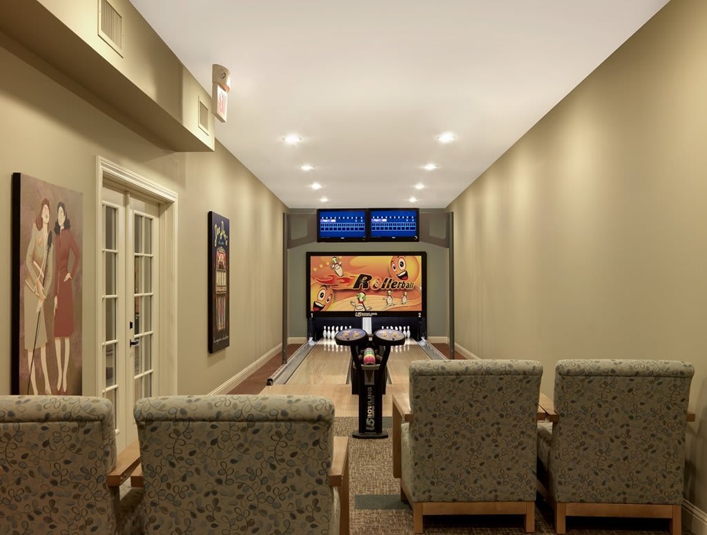 A luxurious home theater setup with a built-in bowling alley.