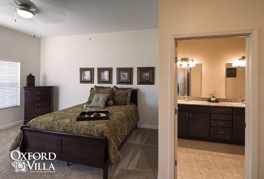 A modern bedroom with an en-suite bathroom, featuring elegant decor and furnishings.
