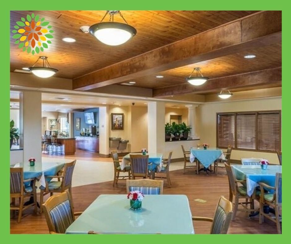 A cozy dining area with neatly arranged tables and chairs, warm lighting, and tasteful decor.
