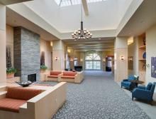 Modern lobby with cozy seating and a fireplace.
