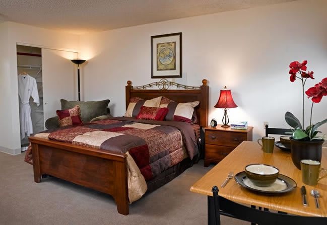 A cozy bedroom with a wooden bed and stylish decor.