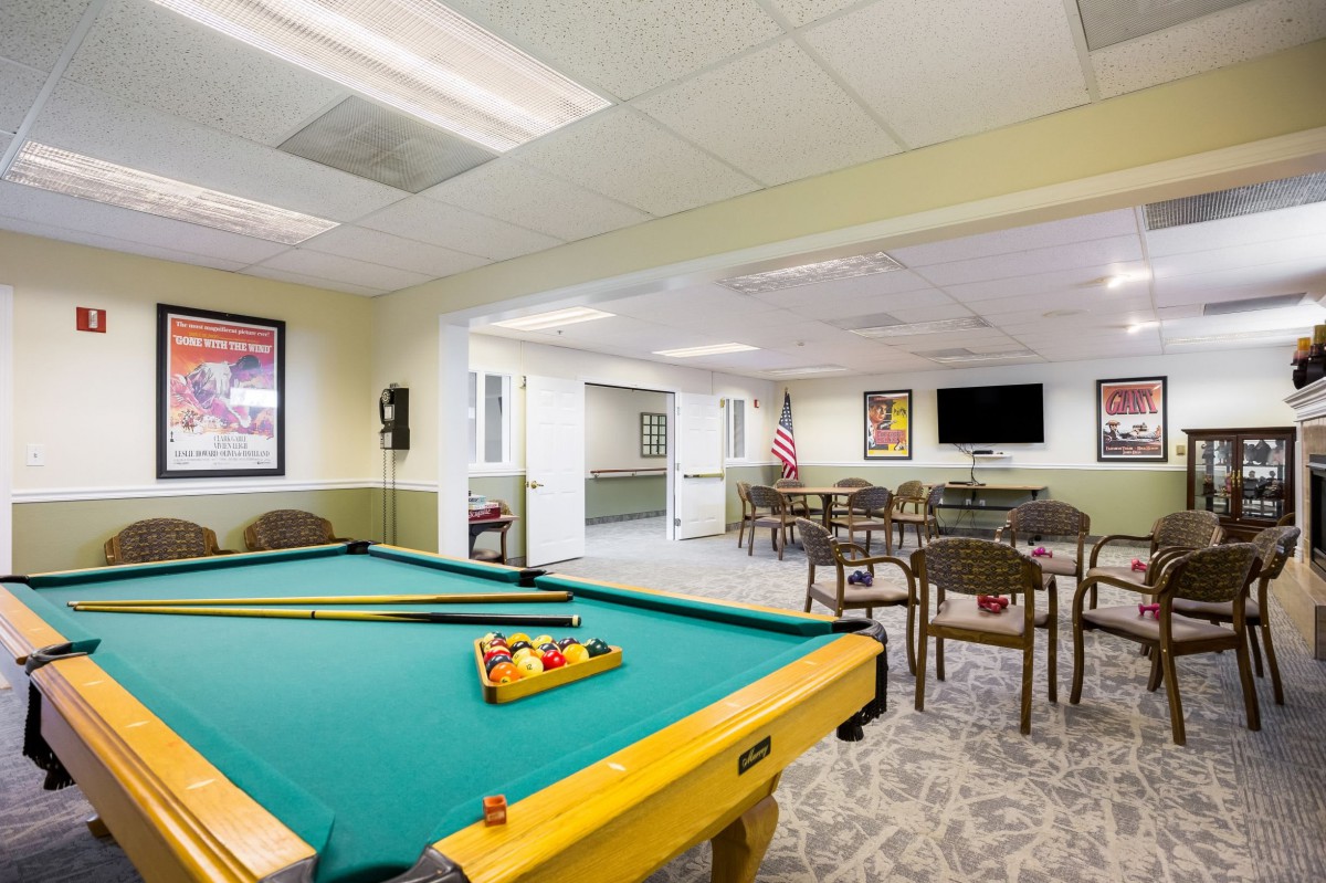 Recreation room with a pool table and seating area.