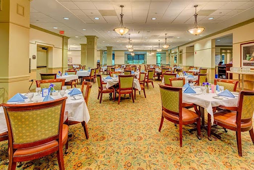 A spacious and elegantly designed dining area, ready for guests with tables set for a meal.