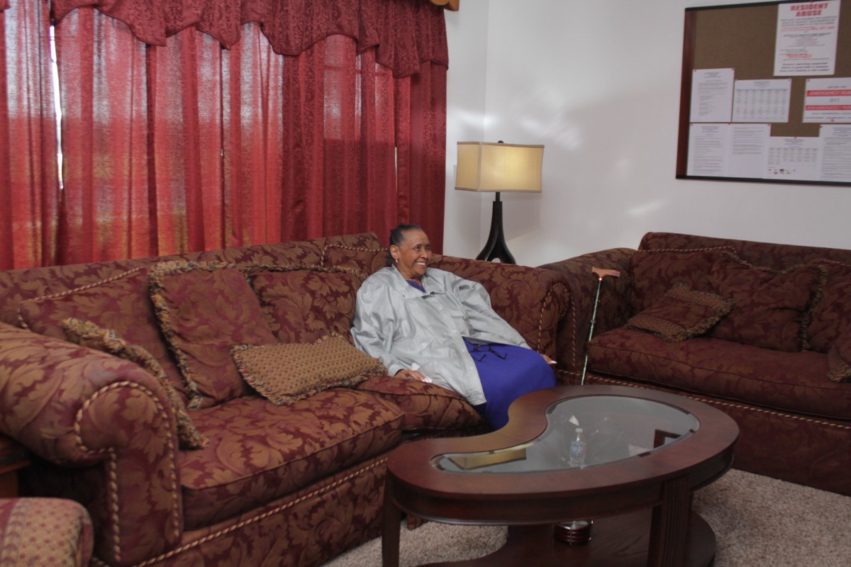 A person sitting on a sofa in a cozy living room.
