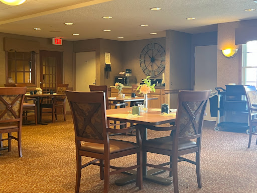 A cozy dining area featuring wooden furniture and warm lighting, perfect for casual gatherings.