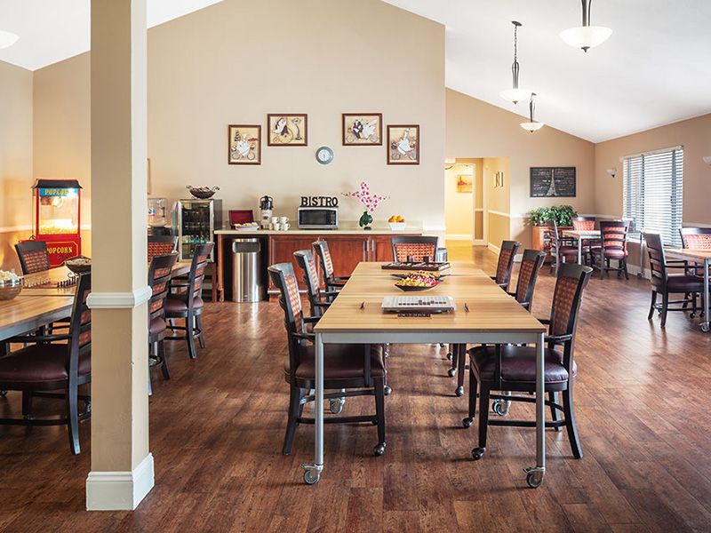Spacious dining room with wooden furniture and elegant decor.