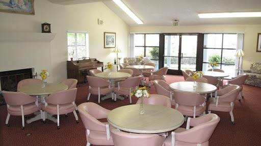 A cozy and inviting lounge area furnished with round tables and comfortable chairs, perfect for gathering.