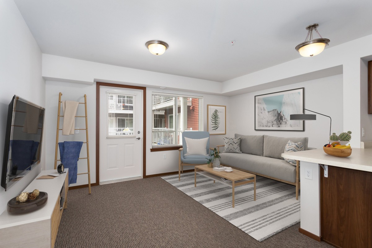 A modern living room featuring a comfortable sofa, coffee table, and stylish decor.