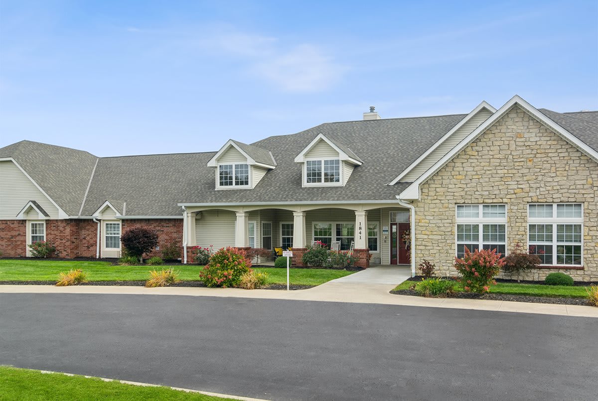 A suburban residential house with a well-maintained lawn and driveway.