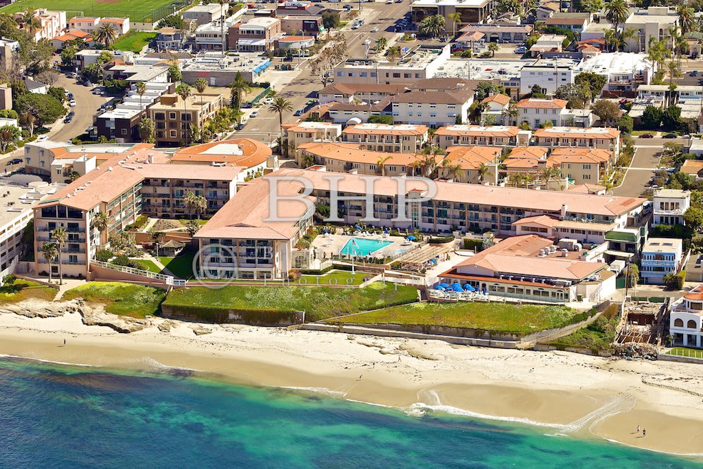 Aerial view of a beachfront resort with surrounding urban area and coastline.