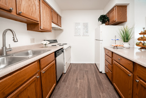 A modern kitchen featuring wooden cabinets and essential appliances.