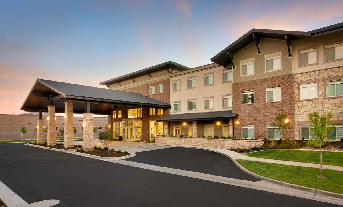 A modern hotel building with a welcoming entrance and well-maintained landscaping.