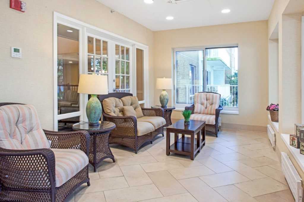 A cozy living room with wicker furniture and ample natural light.