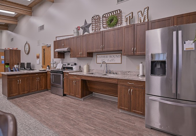 A modern kitchen with wooden cabinets and stainless steel appliances.