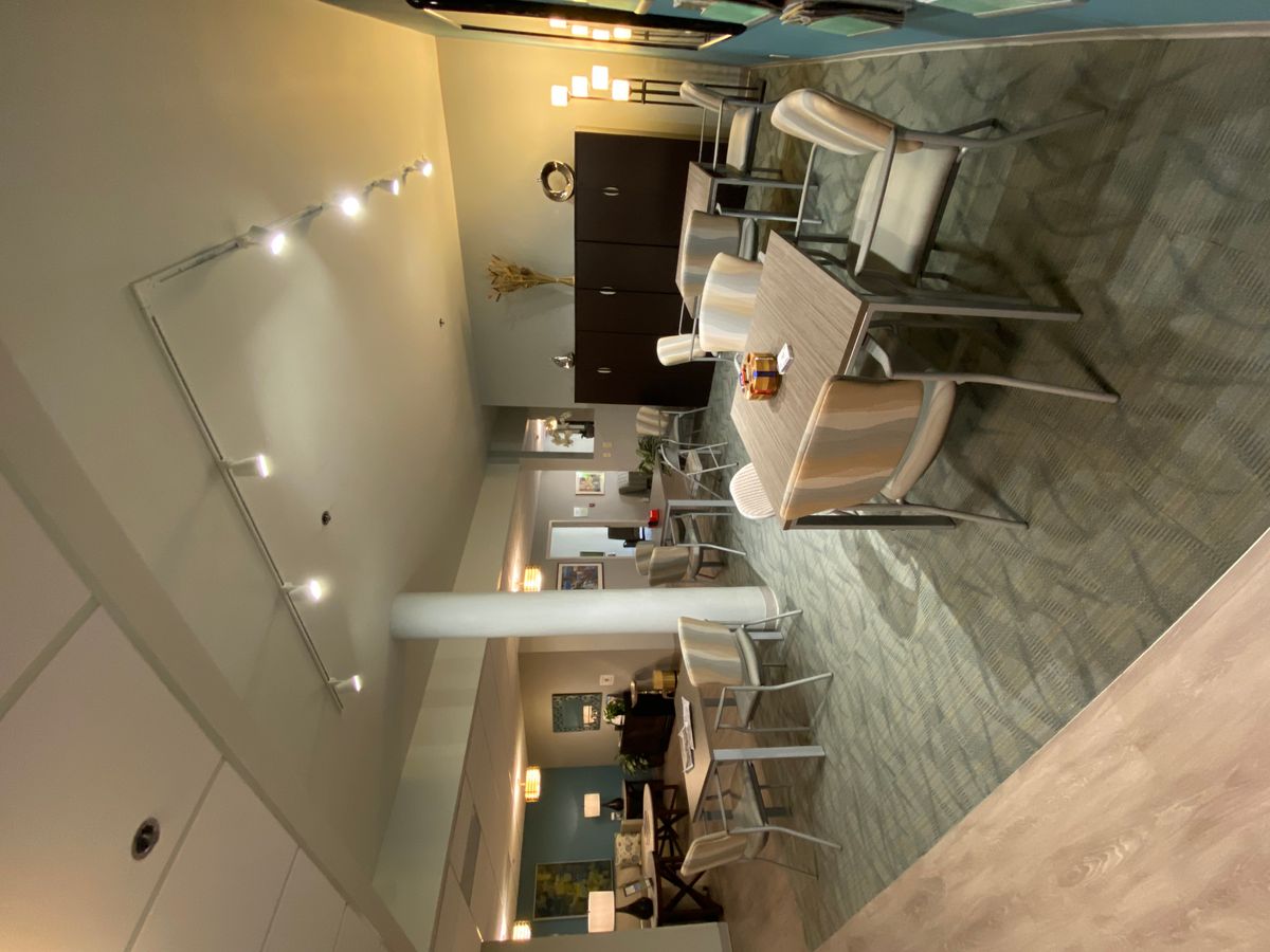 A modern dining area with stylish furniture and warm lighting.