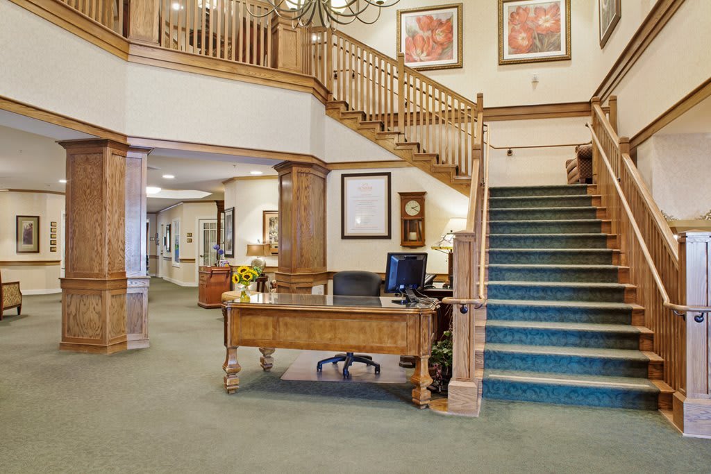 A welcoming lobby area with a staircase and reception desk.