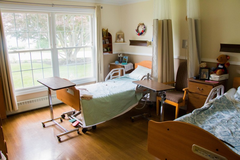 A hospital room with two beds, equipped for patient care.