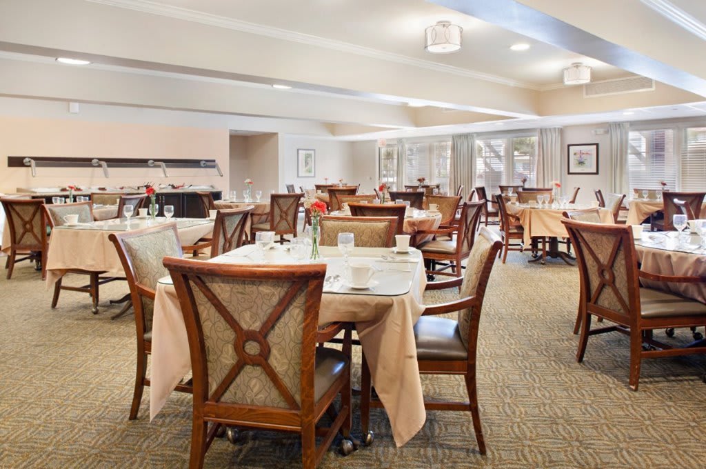 An elegant dining room with neatly arranged tables and chairs, ready for guests.