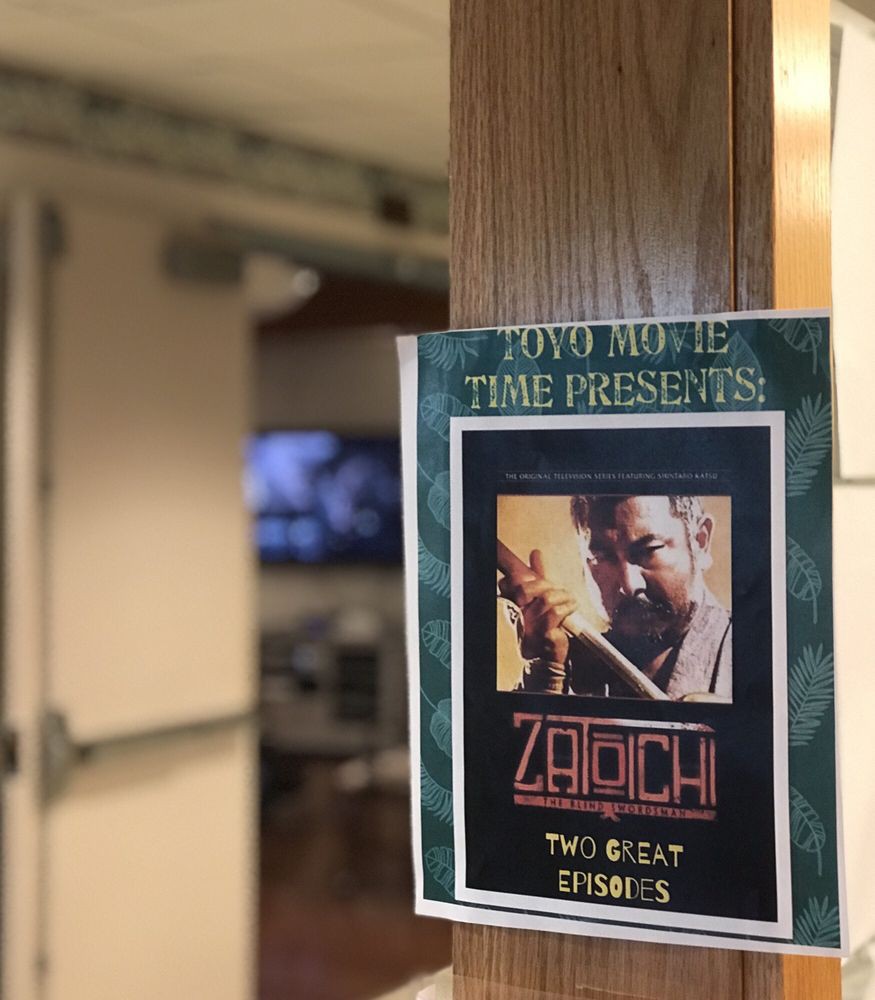 A movie poster titled 'Zatoichi: The Blind Swordsman' is attached to a wooden post indoors.