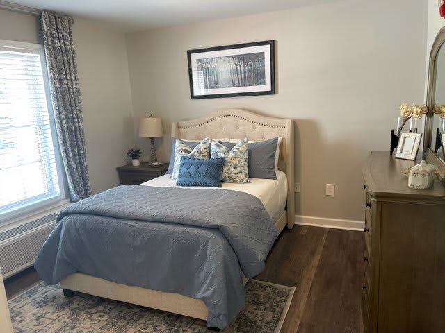 A cozy bedroom with blue bedding and elegant decor.