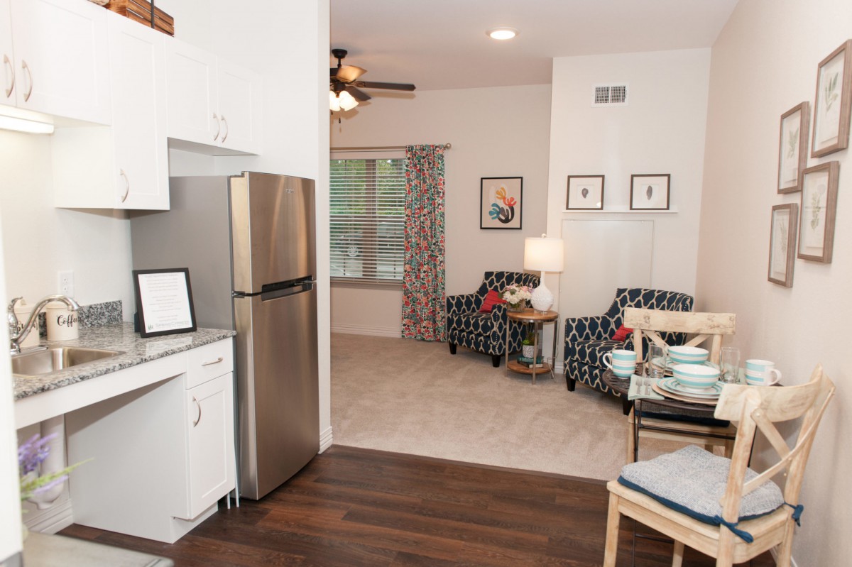 A modern open-concept kitchen and living room with stylish furniture and decor.