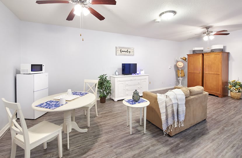 A modern living room with a cozy sofa, dining area, and decorative elements.